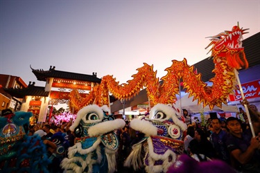 Lit up lion dancers at dusk