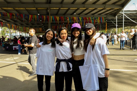 Four friends standing and smiling at Bring It On! Festival