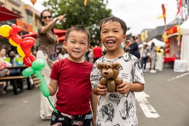 Smiling boys holding balloons at 2026 Cabramatta Lunar New Year.