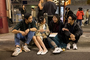 2024 Cabramatta Moon Festival friends on sidewalk eating.