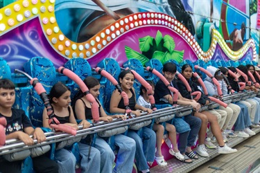 A group of people on the riptide amusement ride at Illuminate NYE 2025