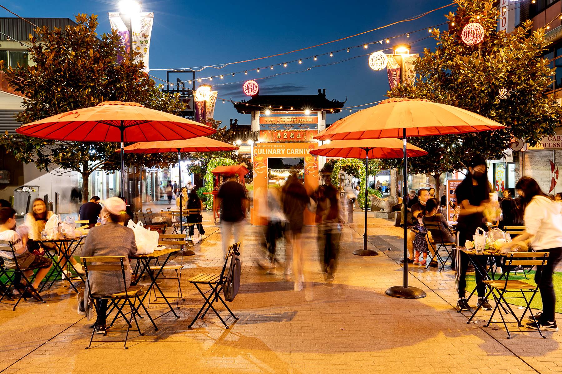 Long exposure shot of Cabramatta main street leading to Pau Lau gates at dusk