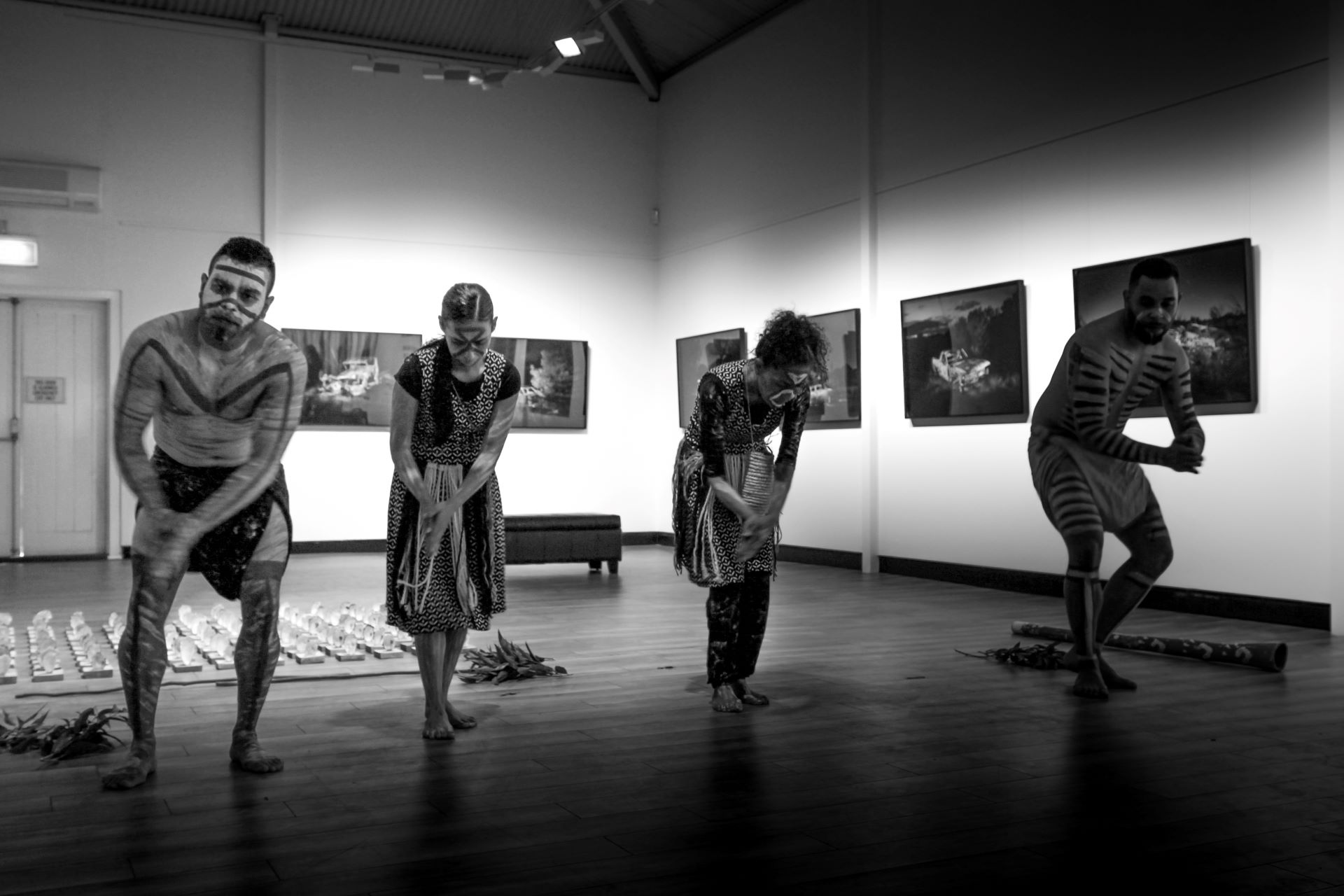 Black and white photo of 4 indigenous dancers inside the Fairfield City Museum and Gallery Foyer