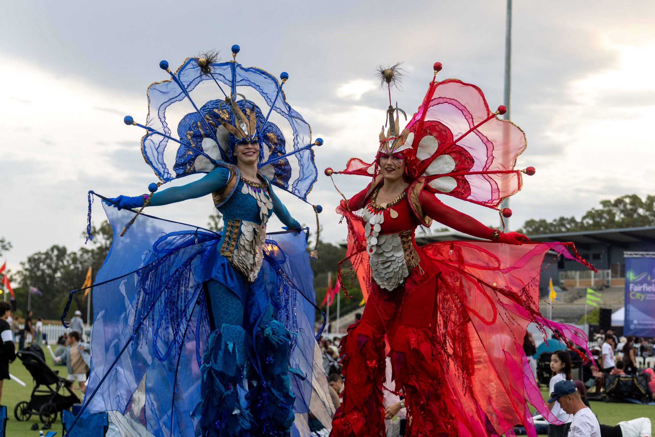 Blue and red stilt walkers at Illuminate NYE