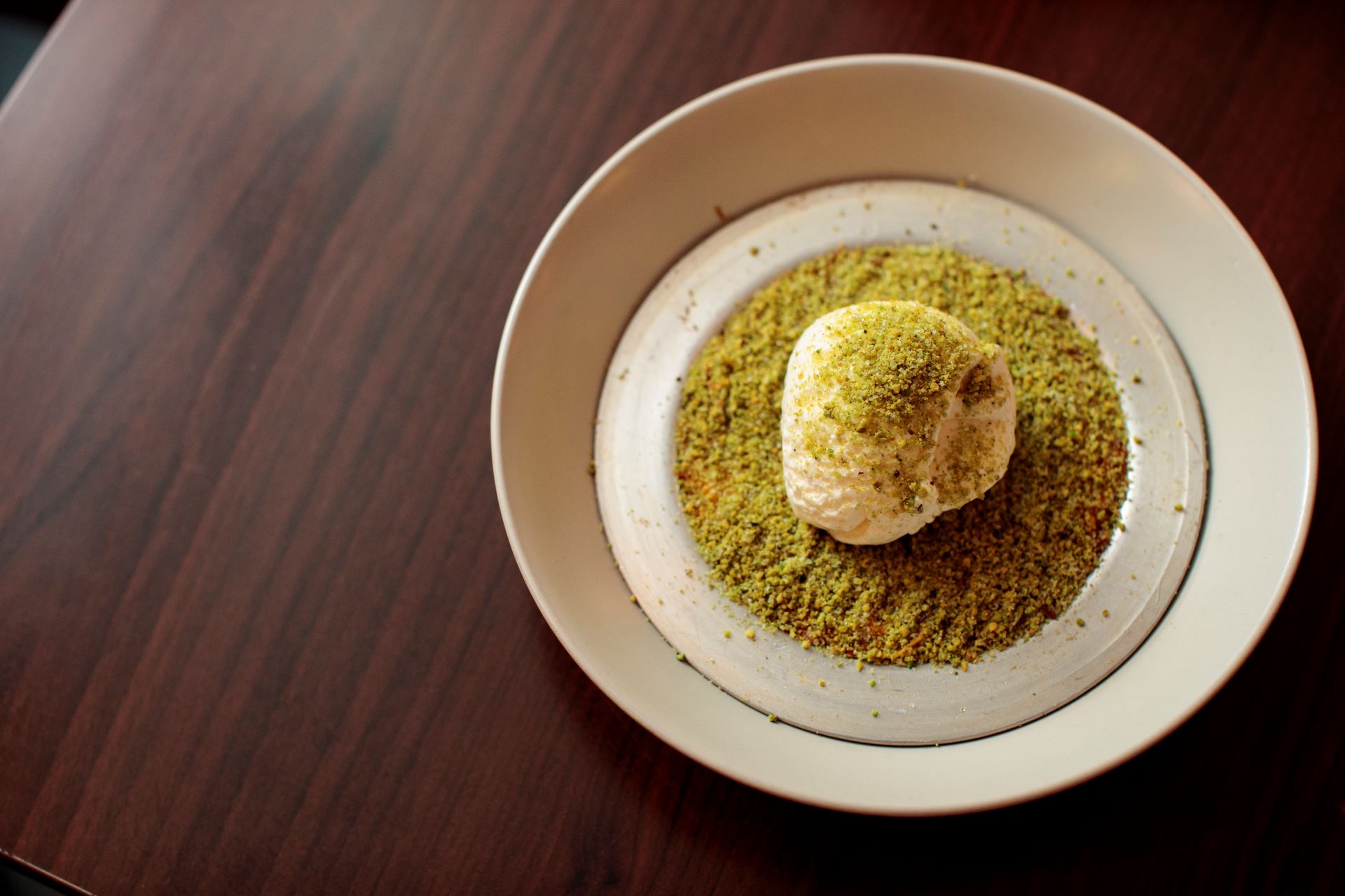 Photo of a green dessert on a white plate 